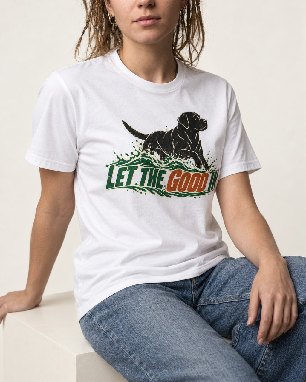 Labrador Retriever Let the Good In T-Shirt in White, worn by a seated model