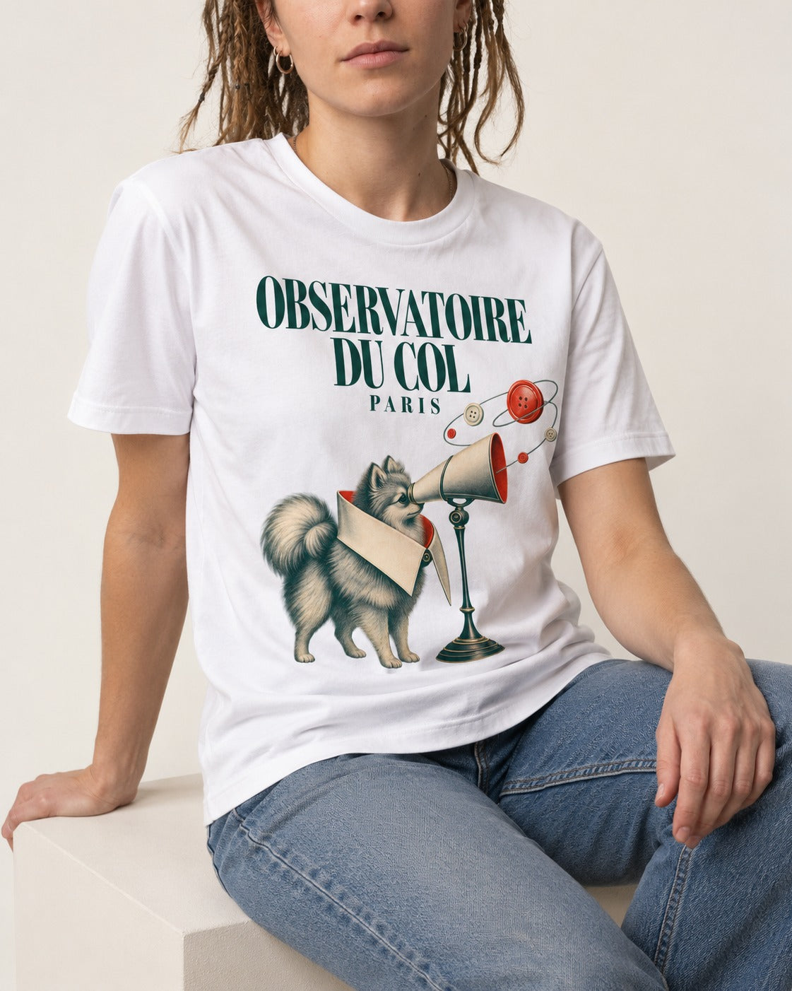 Pomeranian Observatoire Du Col T-Shirt in White, worn by a seated model