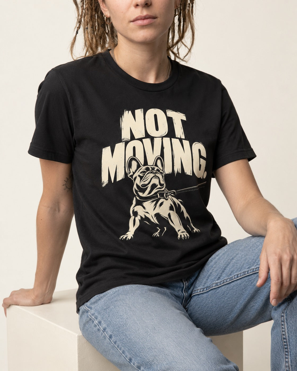 Frenchie Not Moving Taut Leash Poster T-Shirt in Black, worn by a seated model