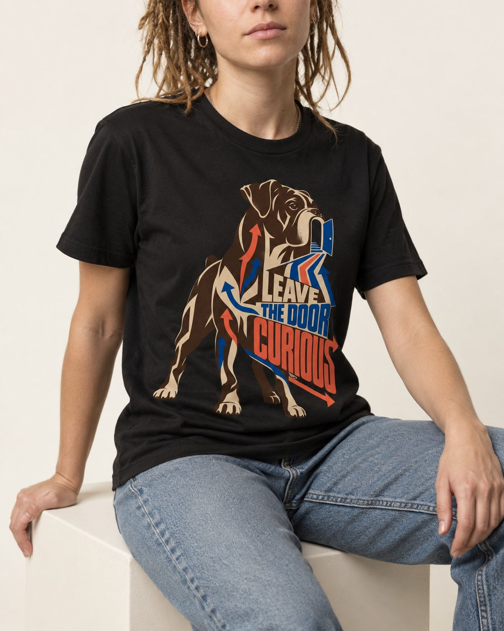 Leave the Door Curious Boxer Doorway Arrow Graphic T-Shirt in Black, worn by a seated model