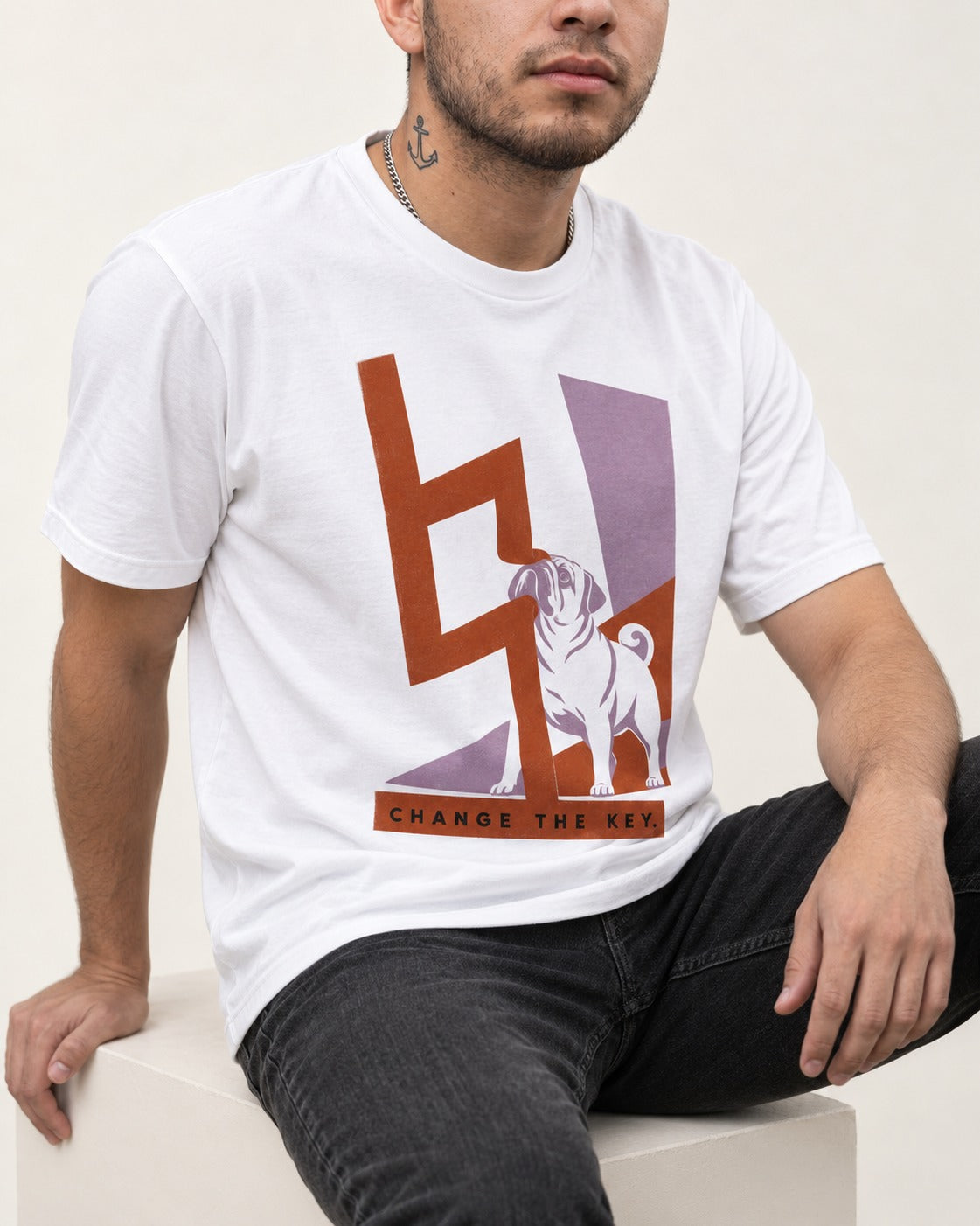 Pug Change the Key T-Shirt in White, worn by a seated model