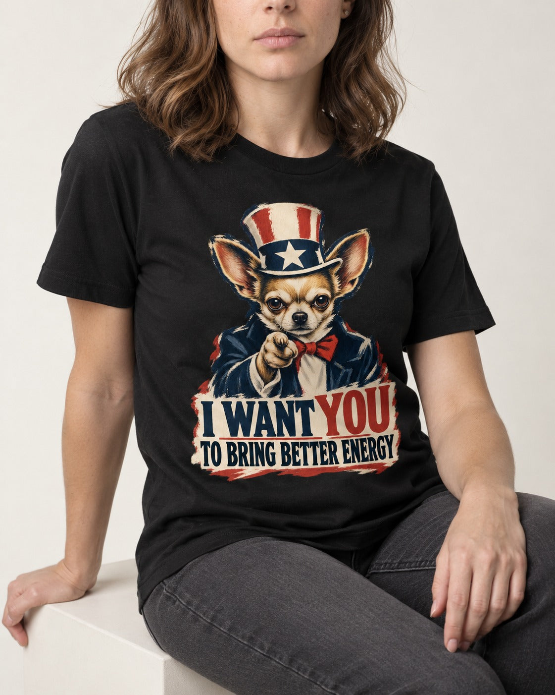 Chihuahua I Want You to Bring Better Energy Uncle Sam Graphic T-Shirt in Black, worn by a seated model