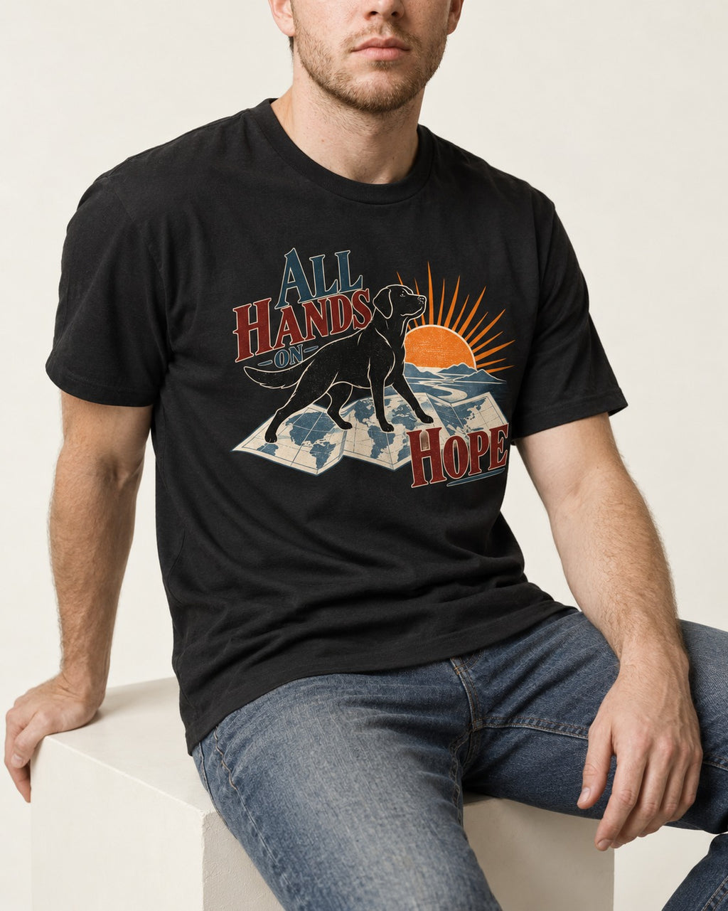 Labrador Retriever All Hands on Hope Map Sunrise Graphic T-Shirt in Black, worn by a seated model
