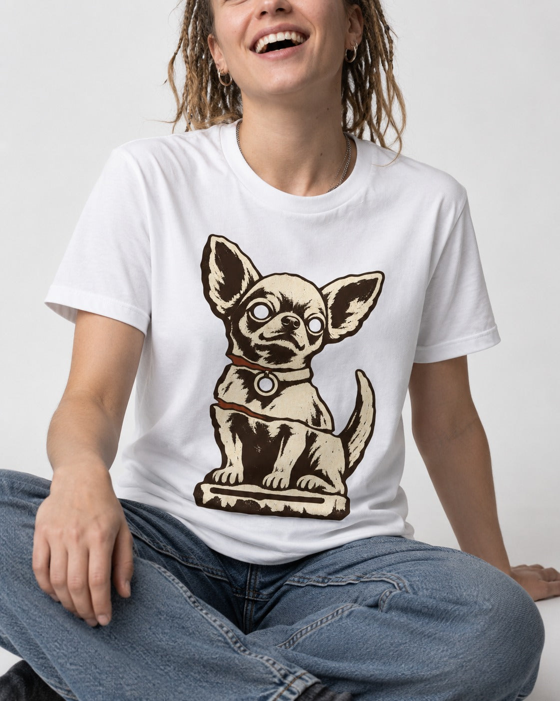 Chihuahua's Eternal Vigil T-Shirt in White, worn by a seated model