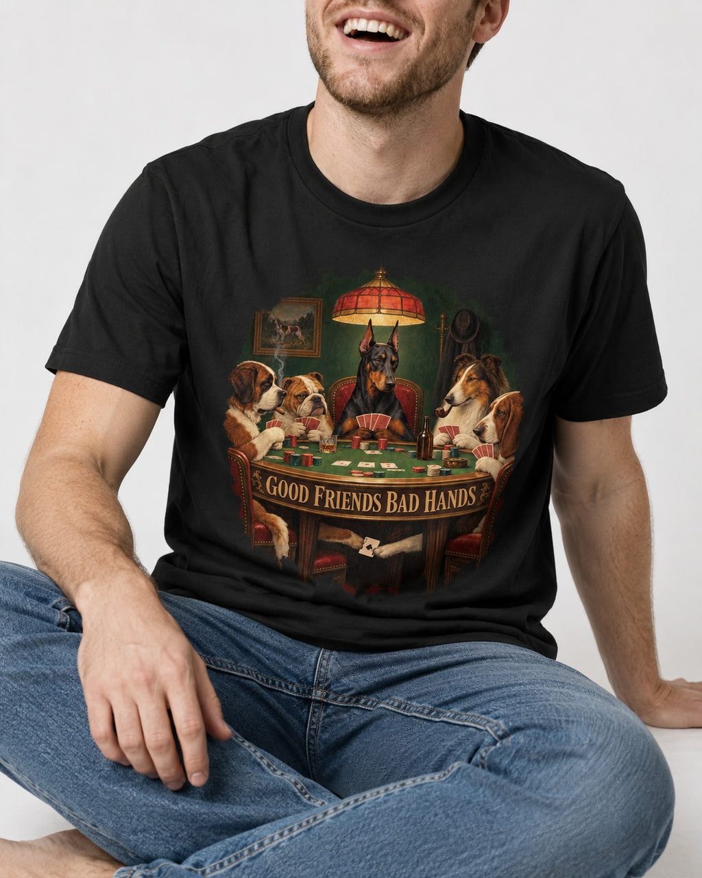 Doberman Good Friends Bad Hands Poker Night Graphic T-Shirt in Black, worn by a seated model