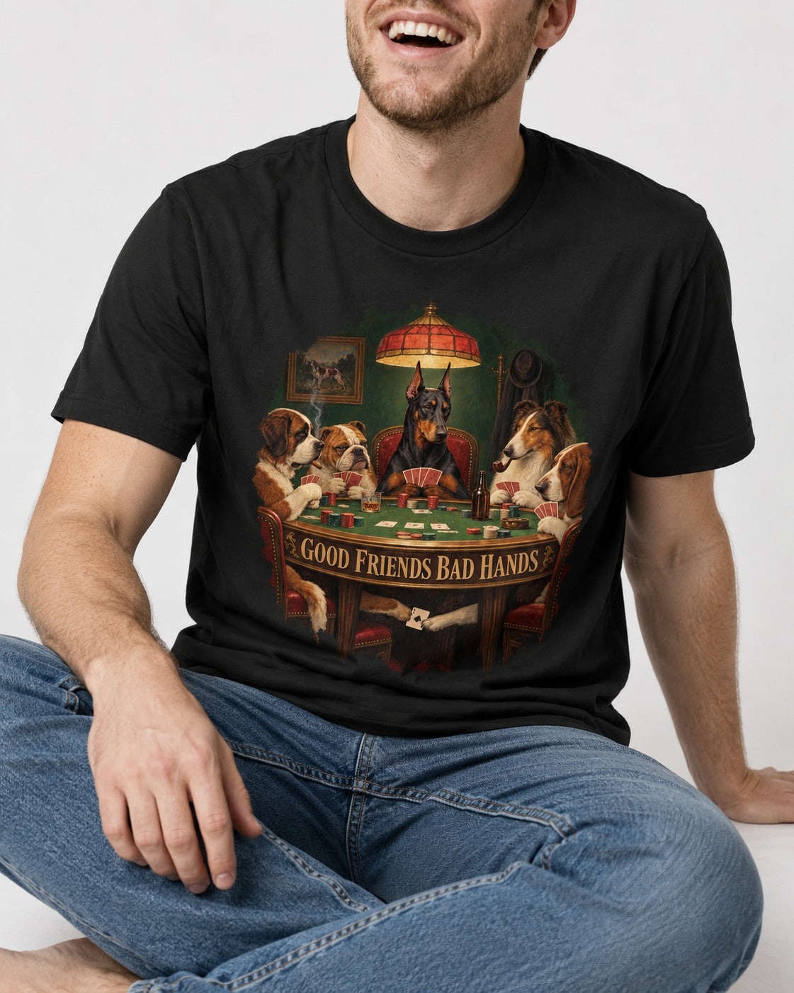 Doberman Good Friends Bad Hands Poker Night Graphic T-Shirt in Black, worn by a seated model