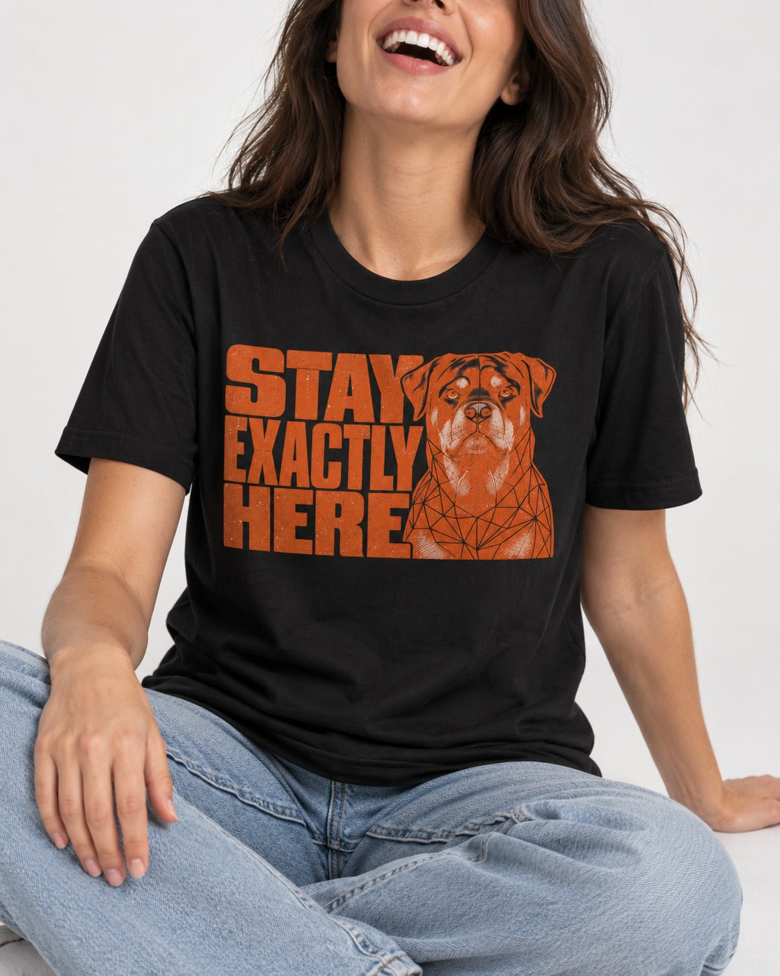 Rottweiler Stay Exactly Here Block Portrait Graphic T-Shirt in Black, worn by a seated model