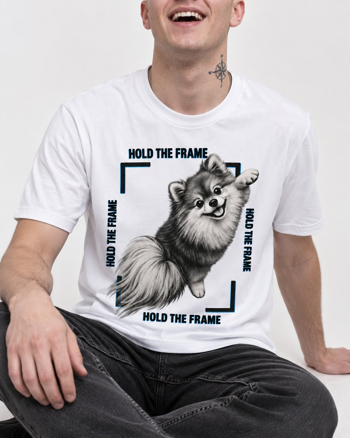 Hold the Frame Pomeranian T-Shirt in White, worn by a seated model