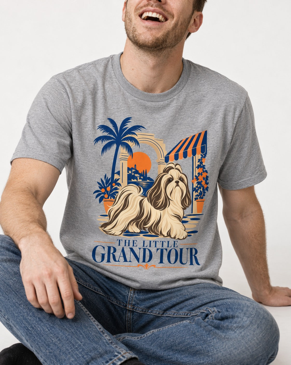 Shih Tzu The Little Grand Tour Mediterranean Courtyard Graphic T-Shirt in Sport Grey, worn by a seated model