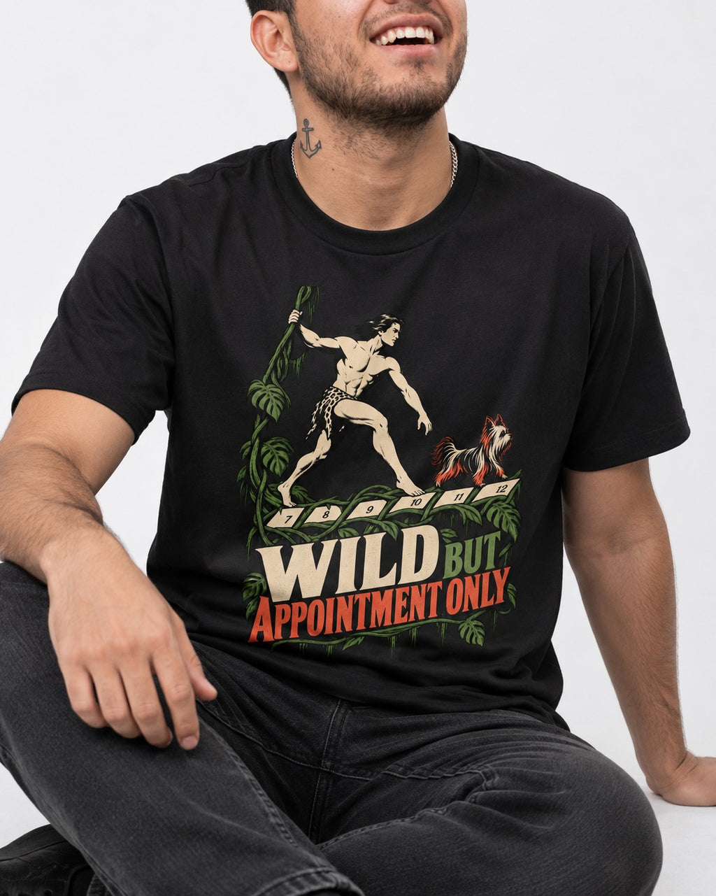 Yorkshire Terrier Wild but Appointment Only Jungle Calendar Graphic T-Shirt in Black, worn by a seated model