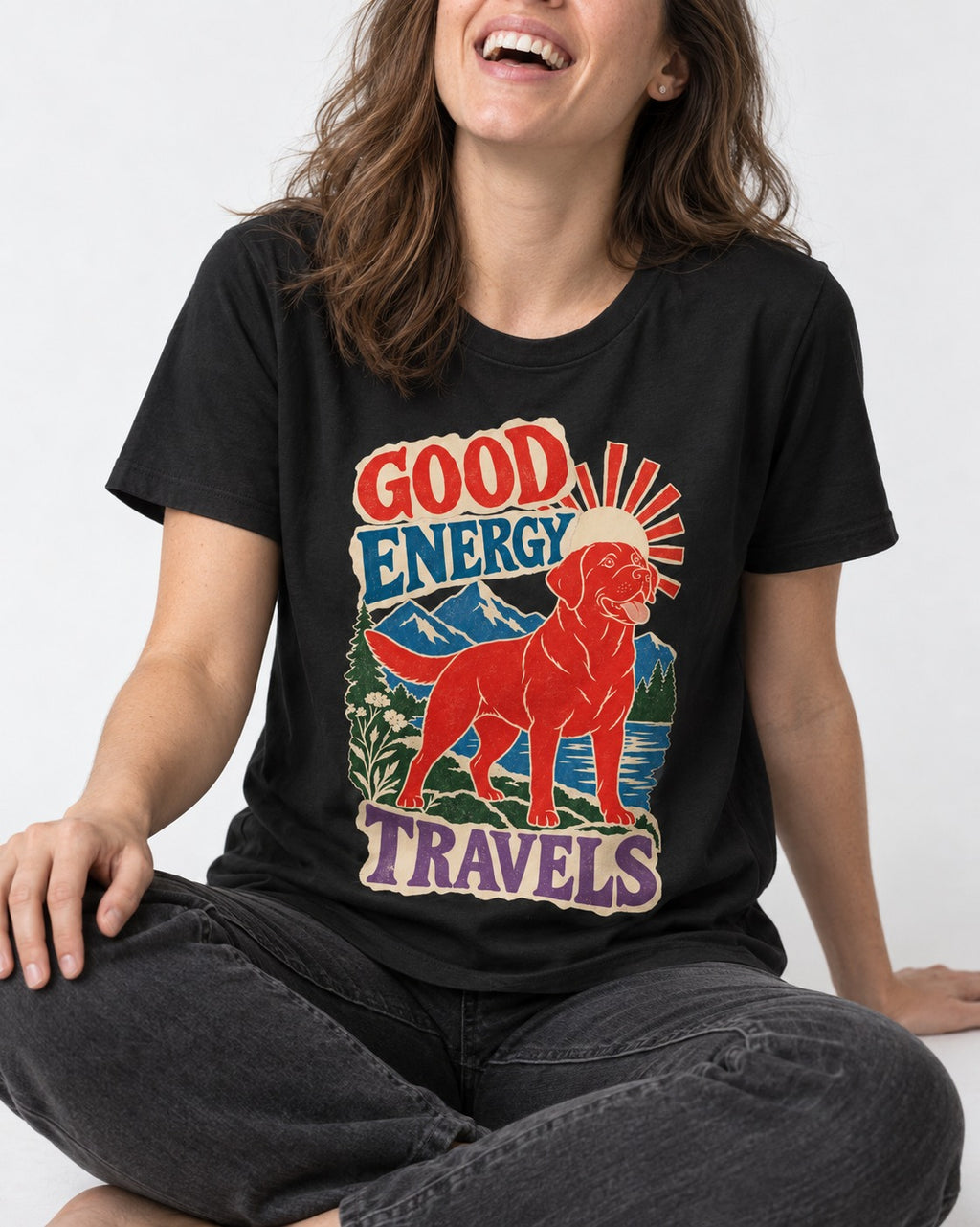 Labrador Retriever Good Energy Travels Adventure Graphic T-Shirt in Black, worn by a seated model