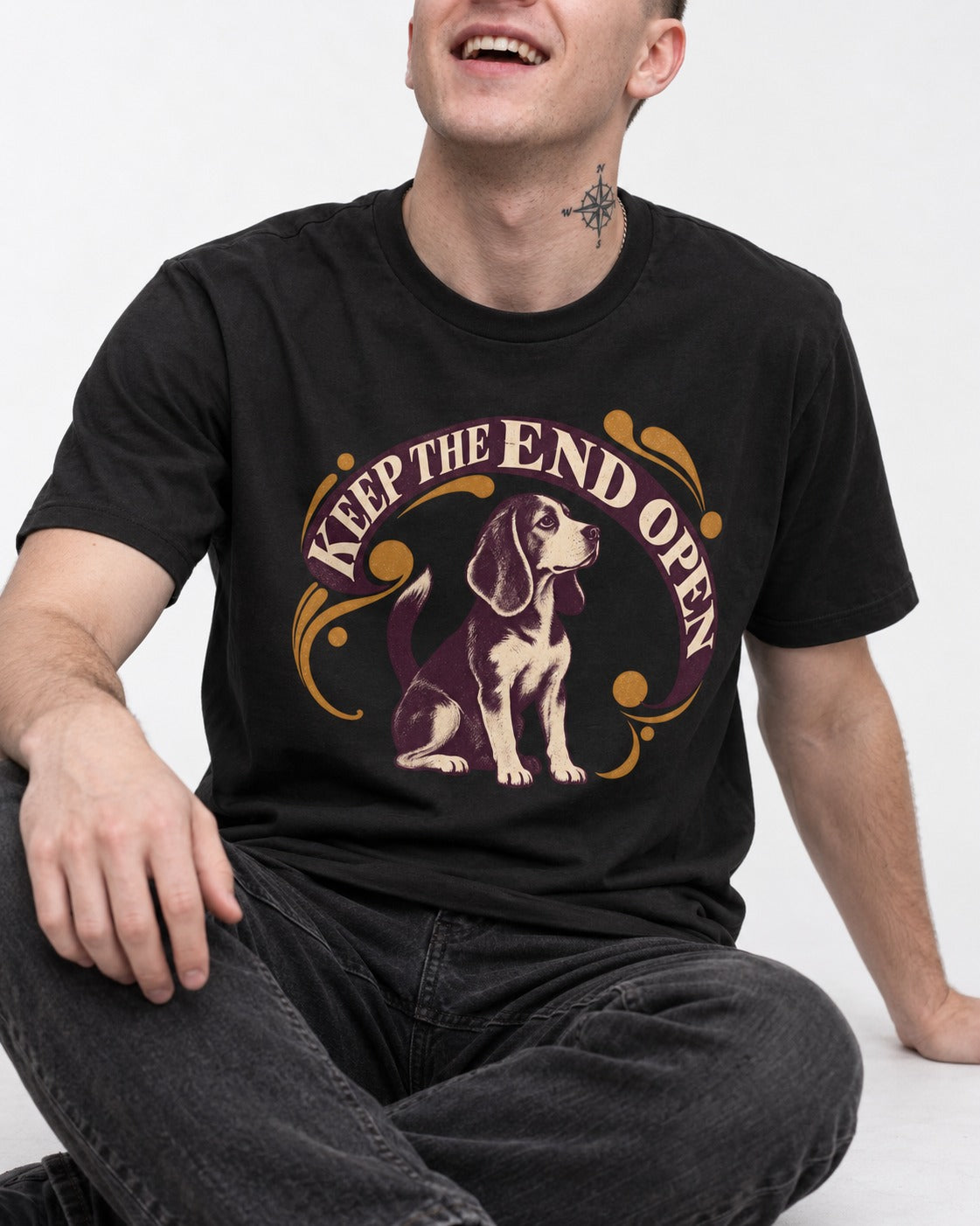 Beagle Keep The End Open Ornamental Graphic T-Shirt in Black, worn by a seated model