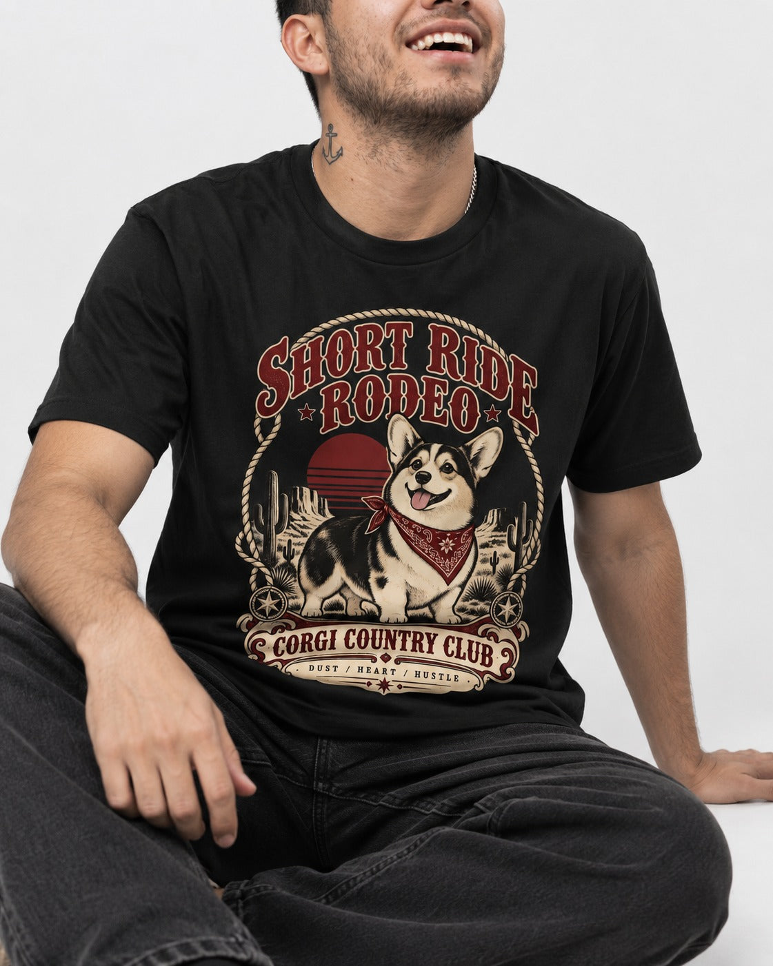Corgi Short Ride Rodeo Country Club Badge T-Shirt in Black, worn by a seated model