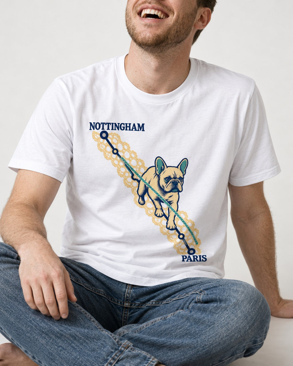 Nottingham to Paris Frenchie T-Shirt in White, worn by a seated model