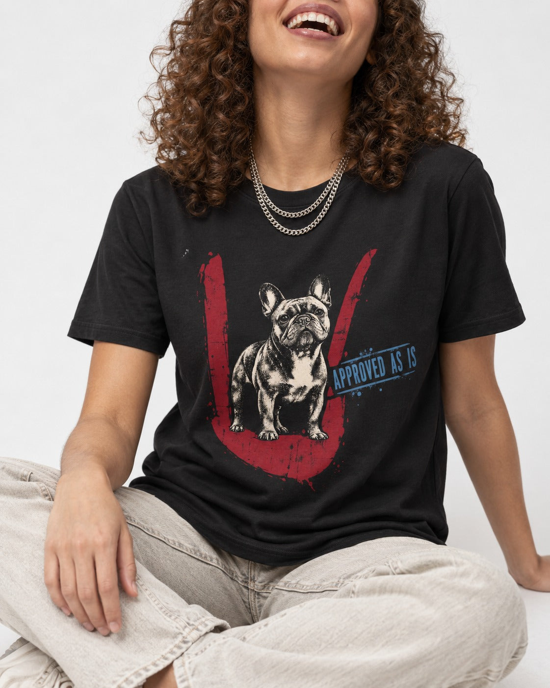 Frenchie Approved As Is Check Mark Graphic T-Shirt in Black, worn by a seated model