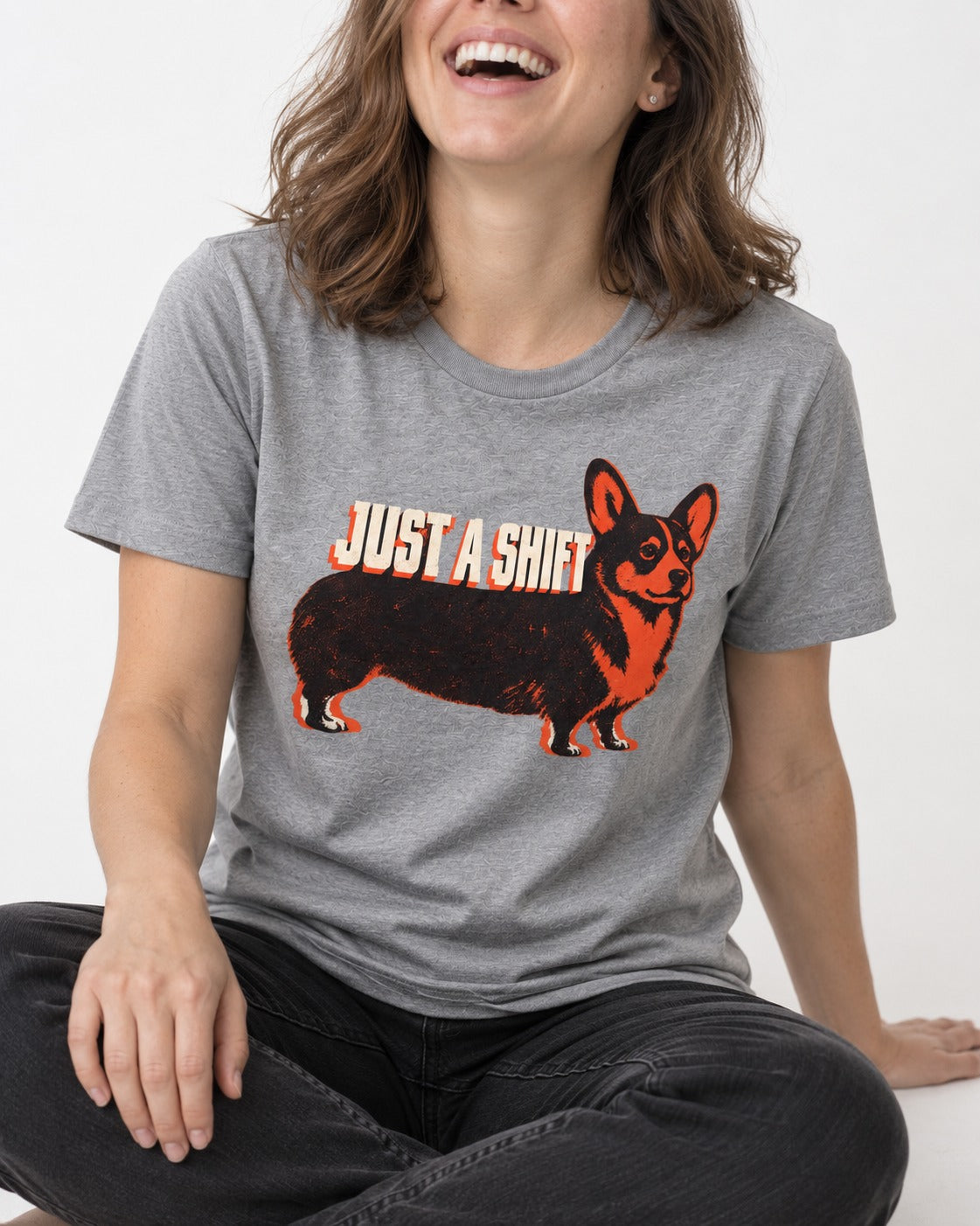 Corgi Just a Shift Typographic Graphic T-Shirt in Sport Grey, worn by a seated model