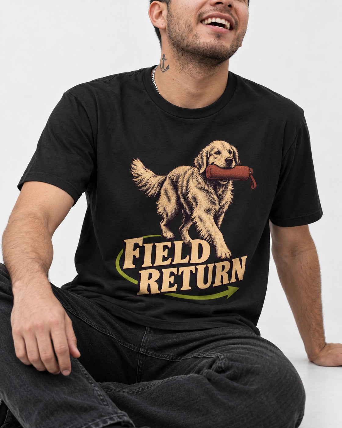 Golden Retriever Field Return Training Dummy Graphic T-Shirt in Black, worn by a seated model