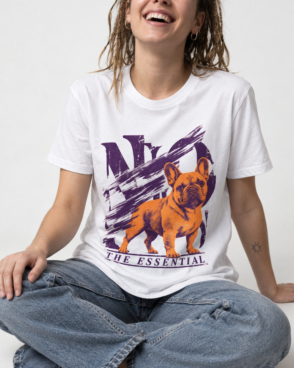 The Essential Frenchie T-Shirt in White, worn by a seated model