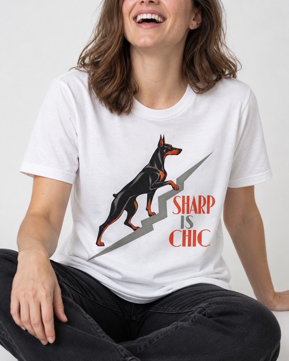 Doberman Is Chic T-Shirt in White, worn by a seated model