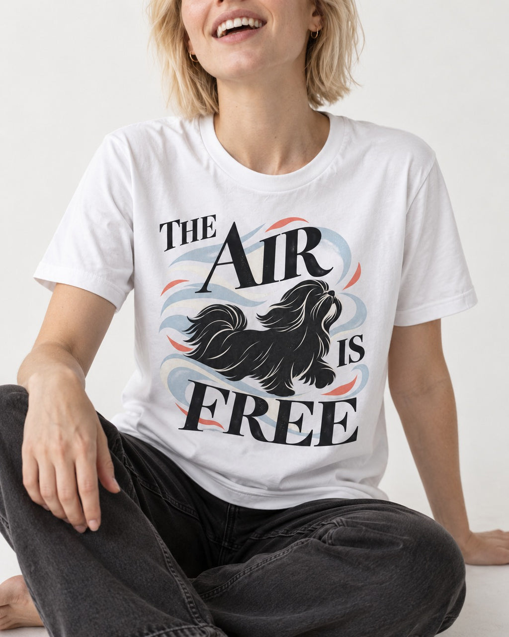 The Air Is Free Shih Tzu T-Shirt in White, worn by a seated model