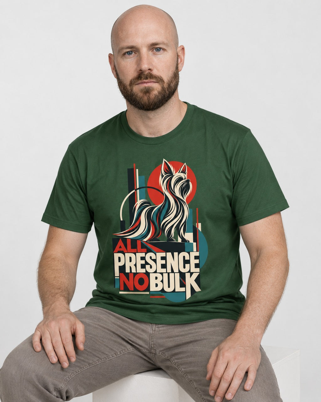 Yorkshire Terrier All Presence No Bulk Geometric Portrait Graphic T-Shirt in Forest Green, worn by a seated model