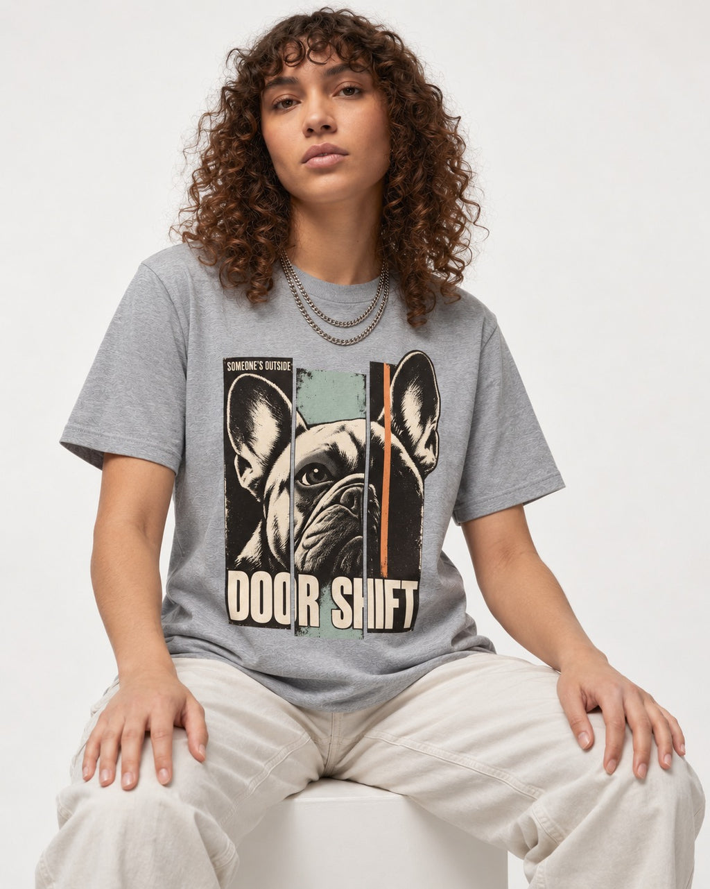 Frenchie Someone's Outside Door Shift Graphic T-Shirt in Sport Grey, worn by a seated model