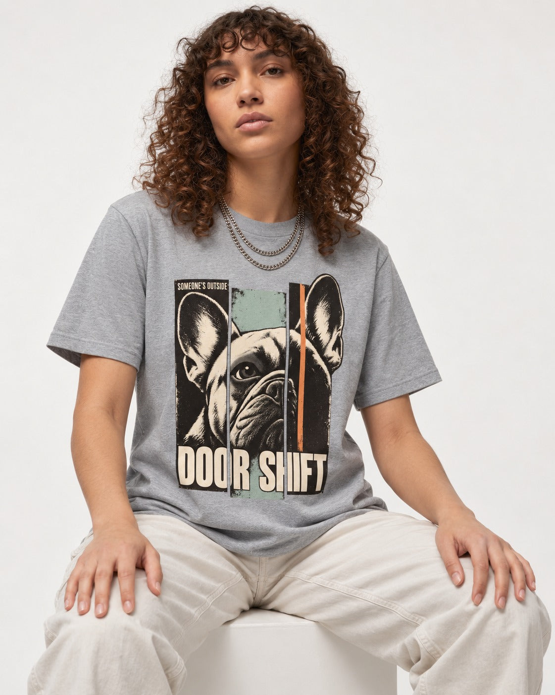 Frenchie Someone's Outside Door Shift Graphic T-Shirt in Sport Grey, worn by a seated model
