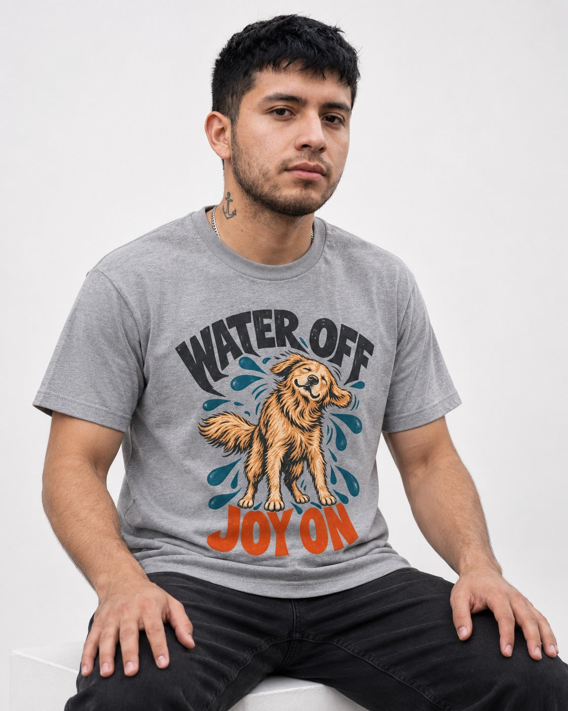 Water Off Joy on Golden Retriever T-Shirt in Sport Grey, worn by a seated model