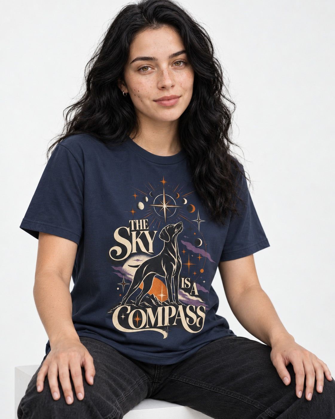 The Sky Is a Compass Celestial German Shorthaired Pointer Graphic T-Shirt in Navy, worn by a seated model