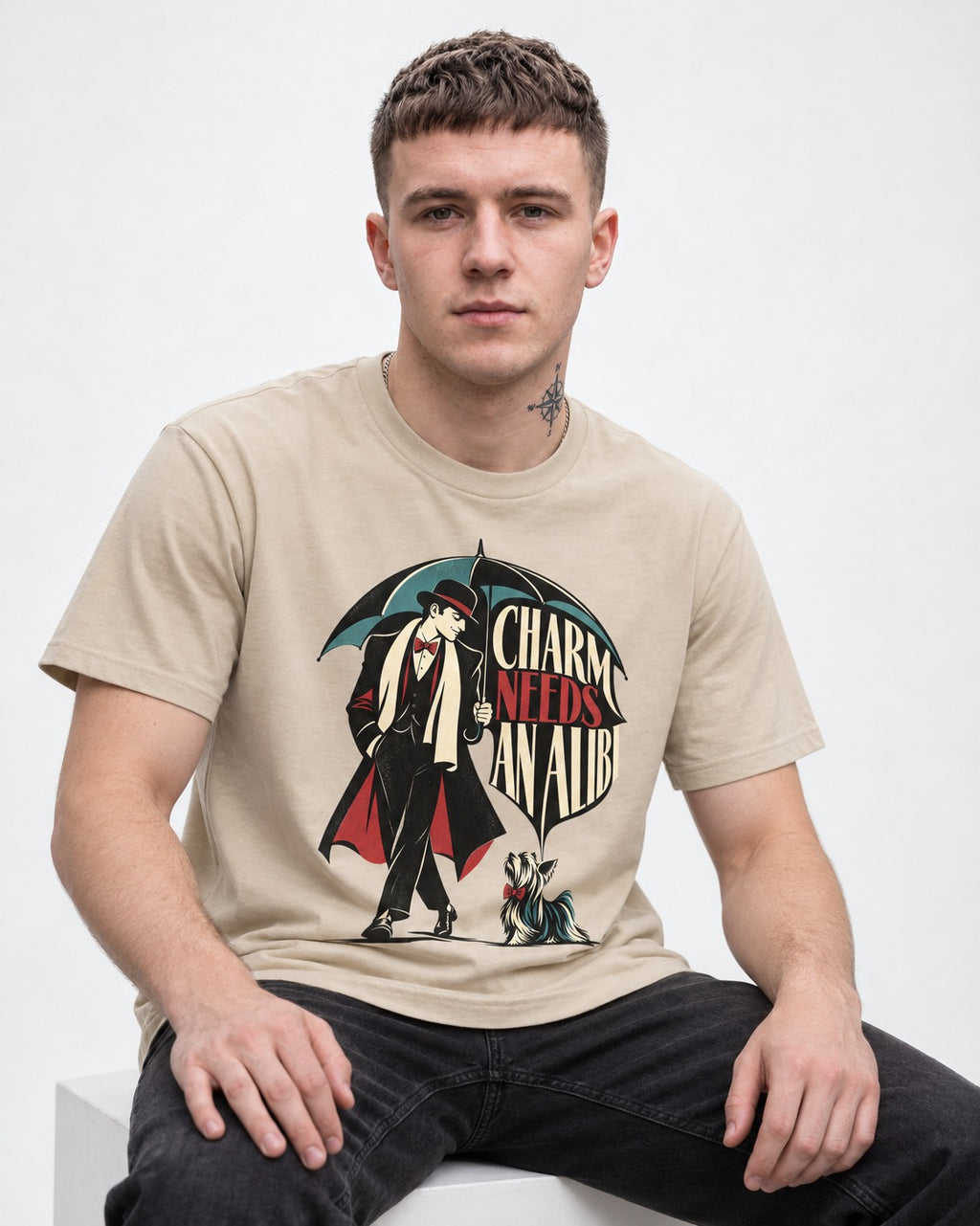 Charm Needs an Alibi Yorkshire Terrier T-Shirt in Sand, worn by a seated model