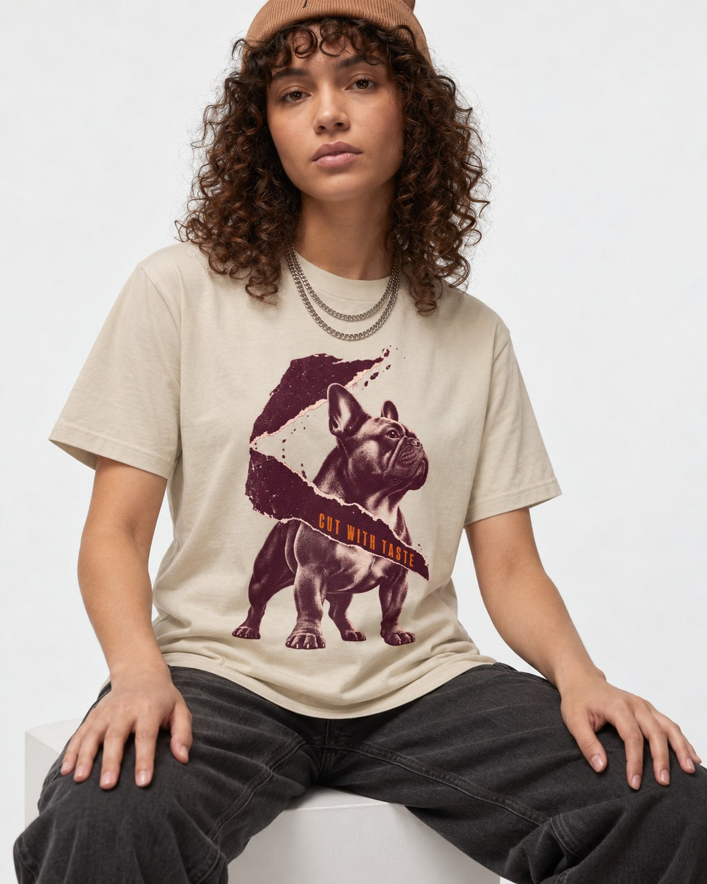 Frenchie Cut with Taste T-Shirt in Sand, worn by a seated model