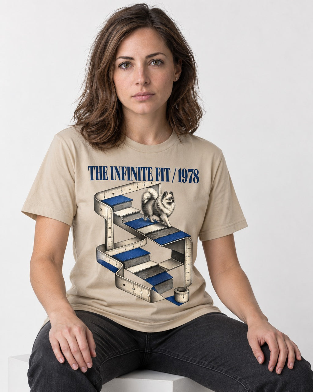 The Infinite Pomeranian Fit T-Shirt in Sand, worn by a seated model