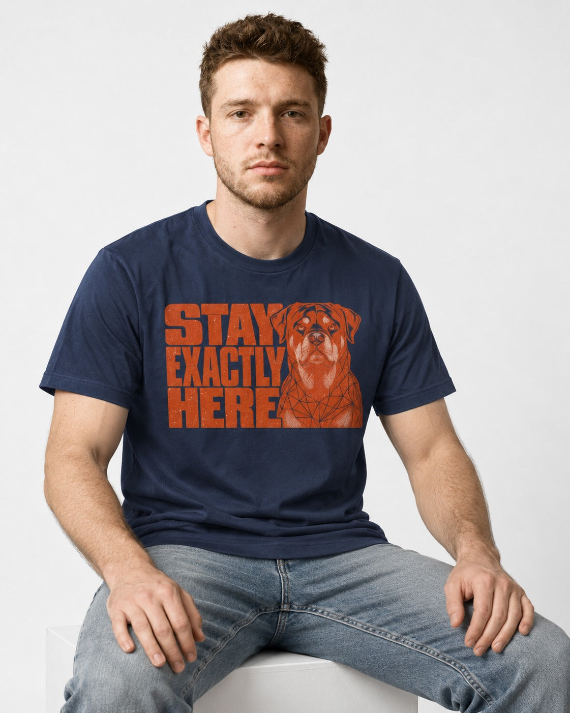 Rottweiler Stay Exactly Here Block Portrait Graphic T-Shirt in Navy, worn by a seated model