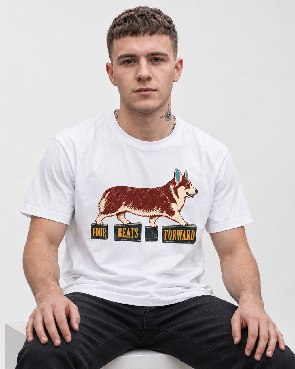 Corgi Four Beats Forward T-Shirt in White, worn by a seated model