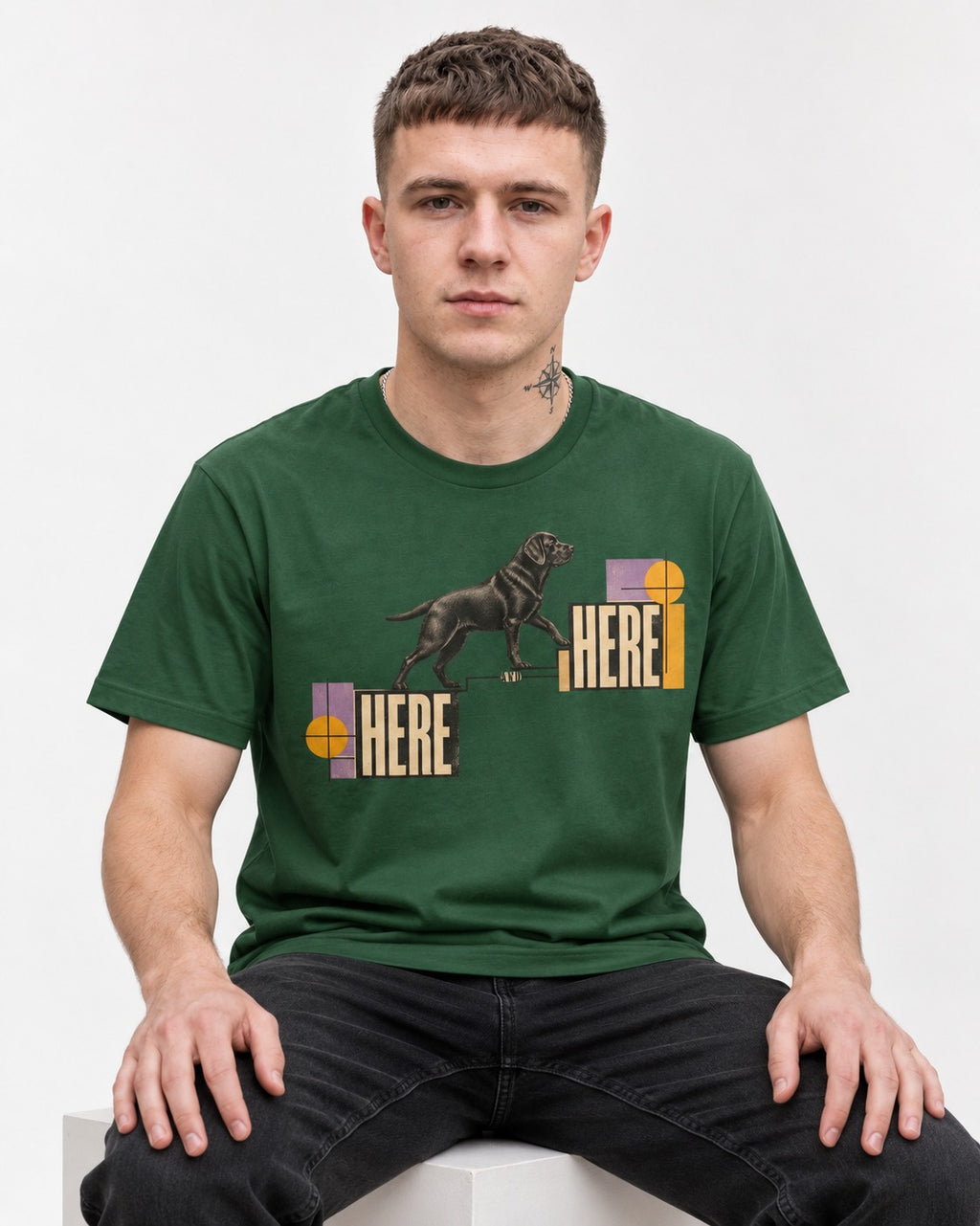 Here and Here Stepping Labrador Retriever Graphic T-Shirt in Forest Green, worn by a seated model