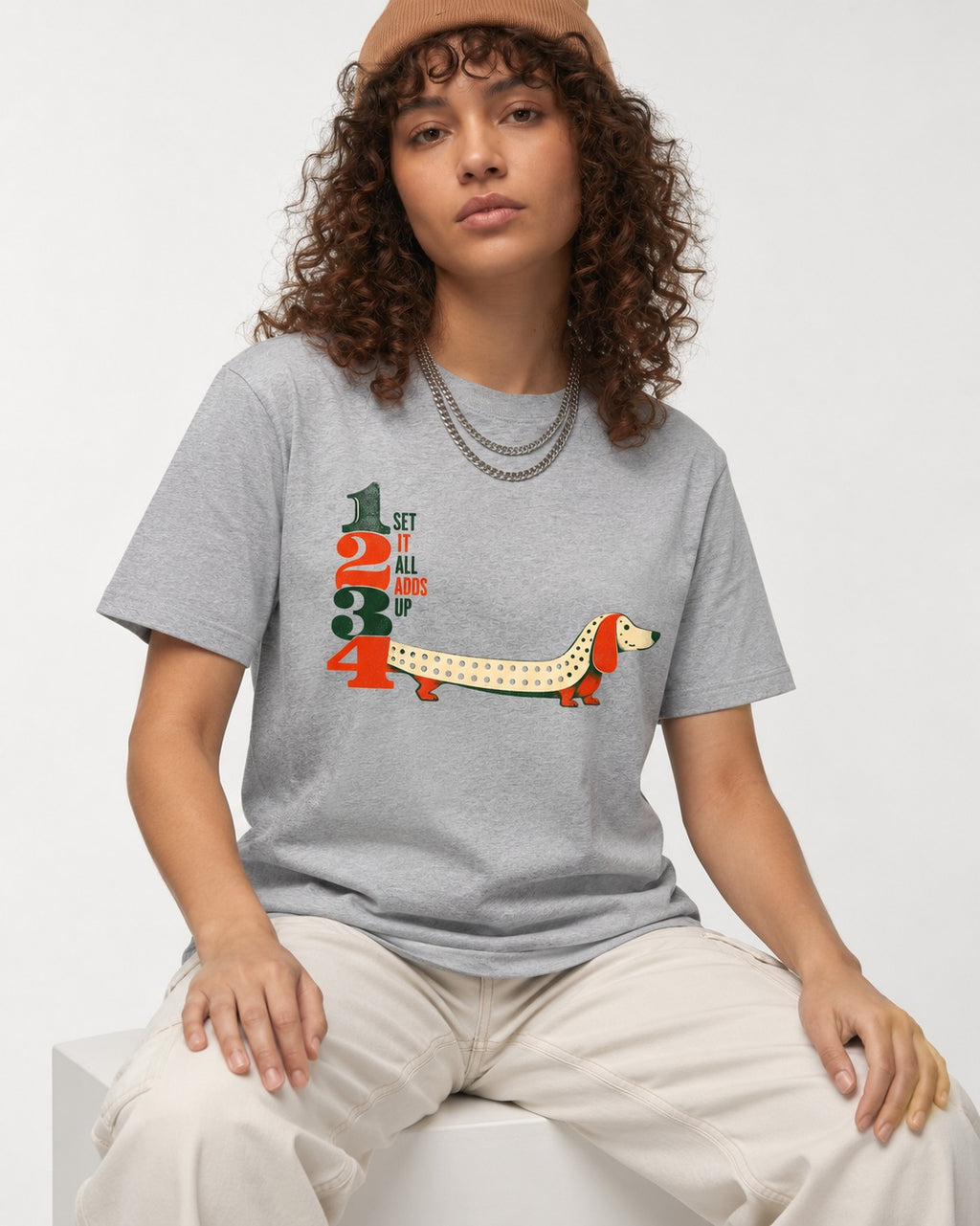 Dachshund Adds Up T-Shirt in Sport Grey, worn by a seated model
