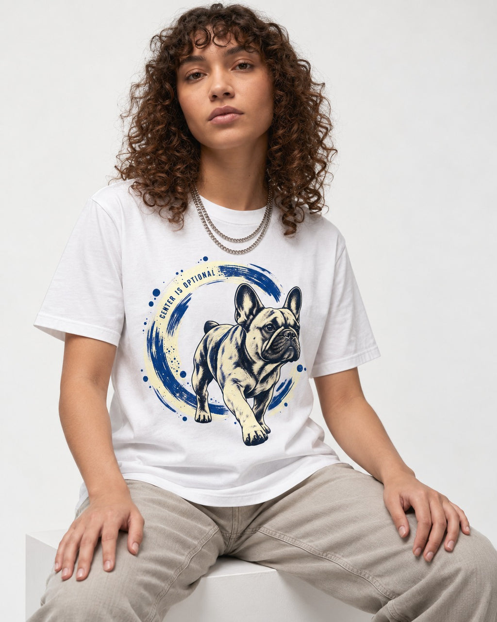 Frenchie Center Is Optional Brush Circle Graphic T-Shirt in White, worn by a seated model