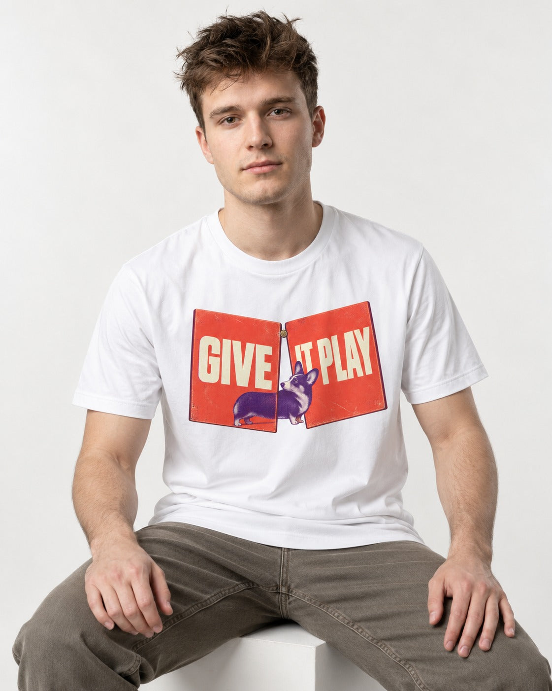 Corgi Give It Play Folding Panels T-Shirt in White, worn by a seated model