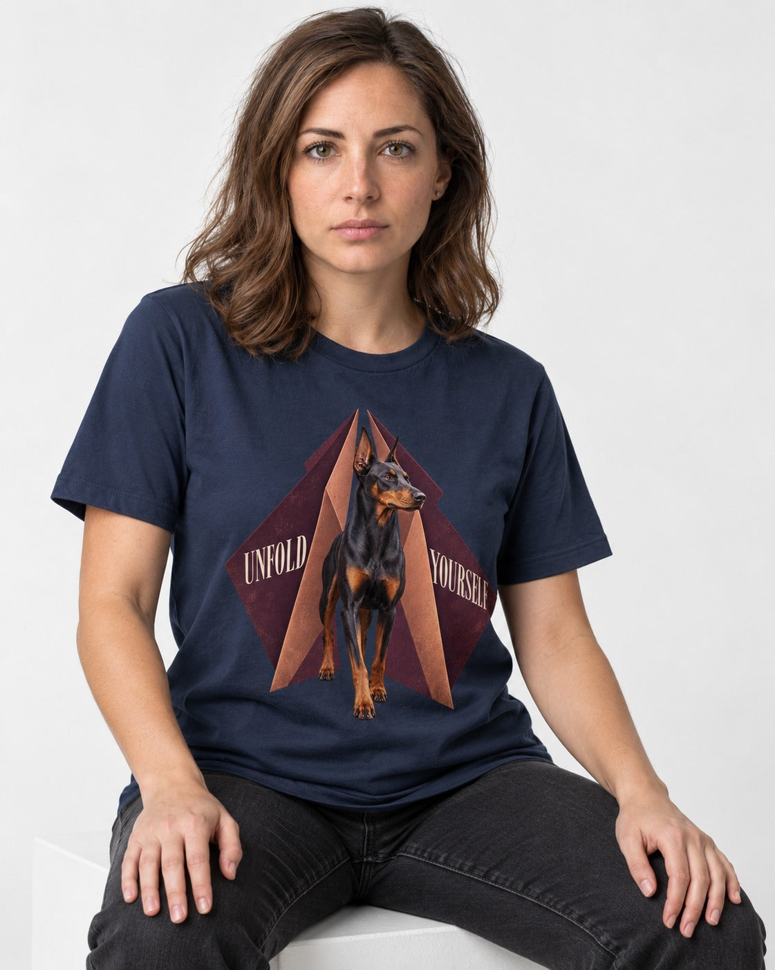 Doberman Unfold Yourself Geometric Portrait Graphic T-Shirt in Navy, worn by a seated model