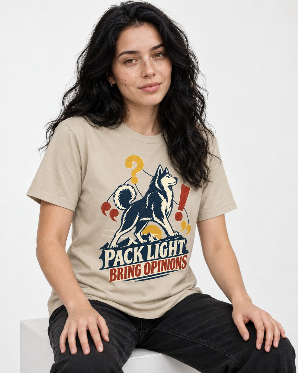 Husky Pack Light Bring Opinions T-Shirt in Sand, worn by a seated model