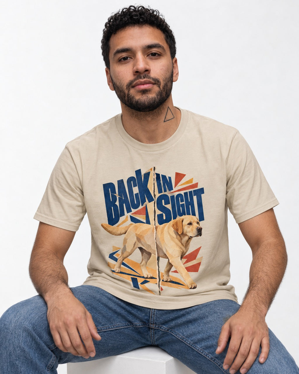 Labrador Retriever Back in Sight T-Shirt in Sand, worn by a seated model