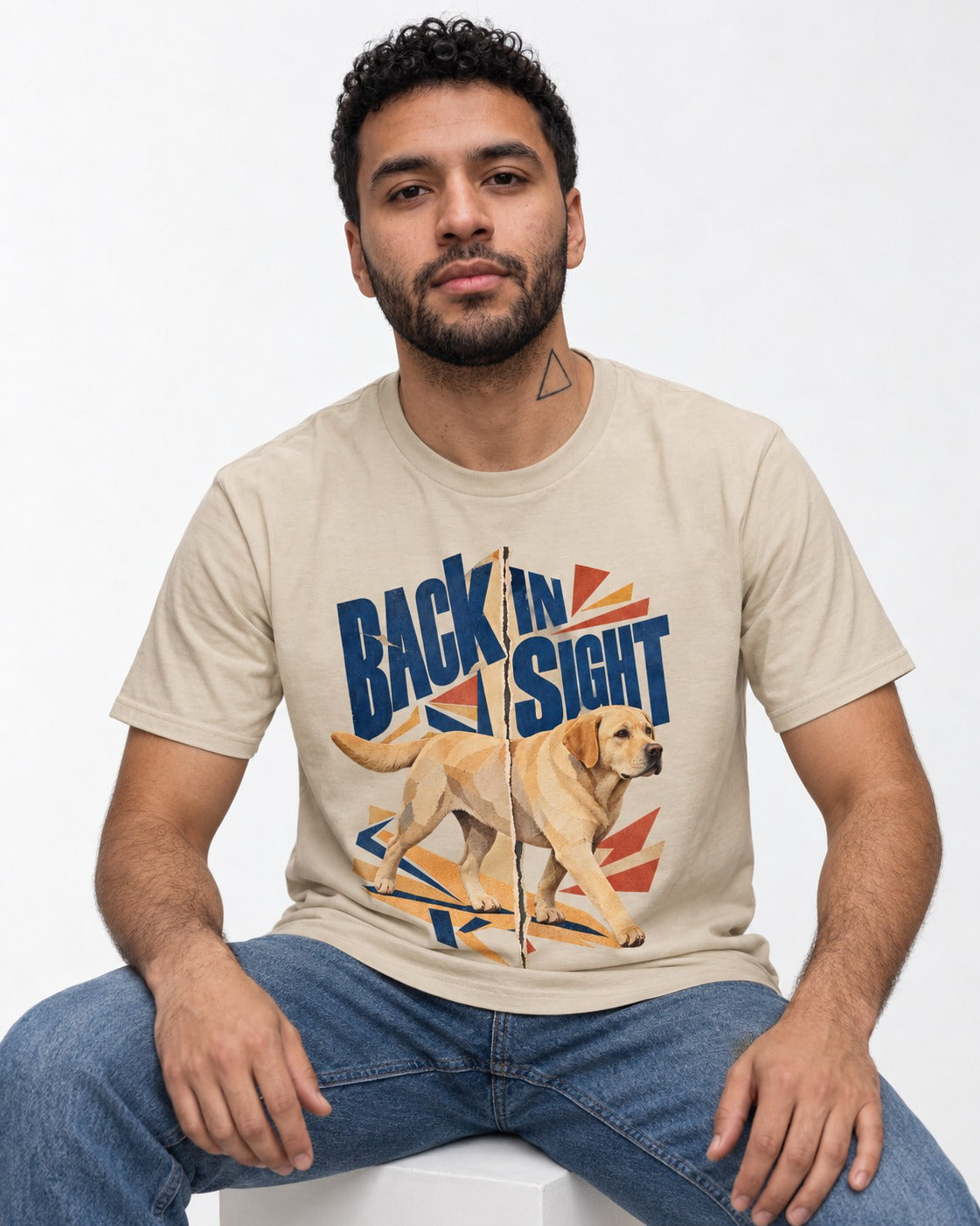 Labrador Retriever Back in Sight T-Shirt in Sand, worn by a seated model