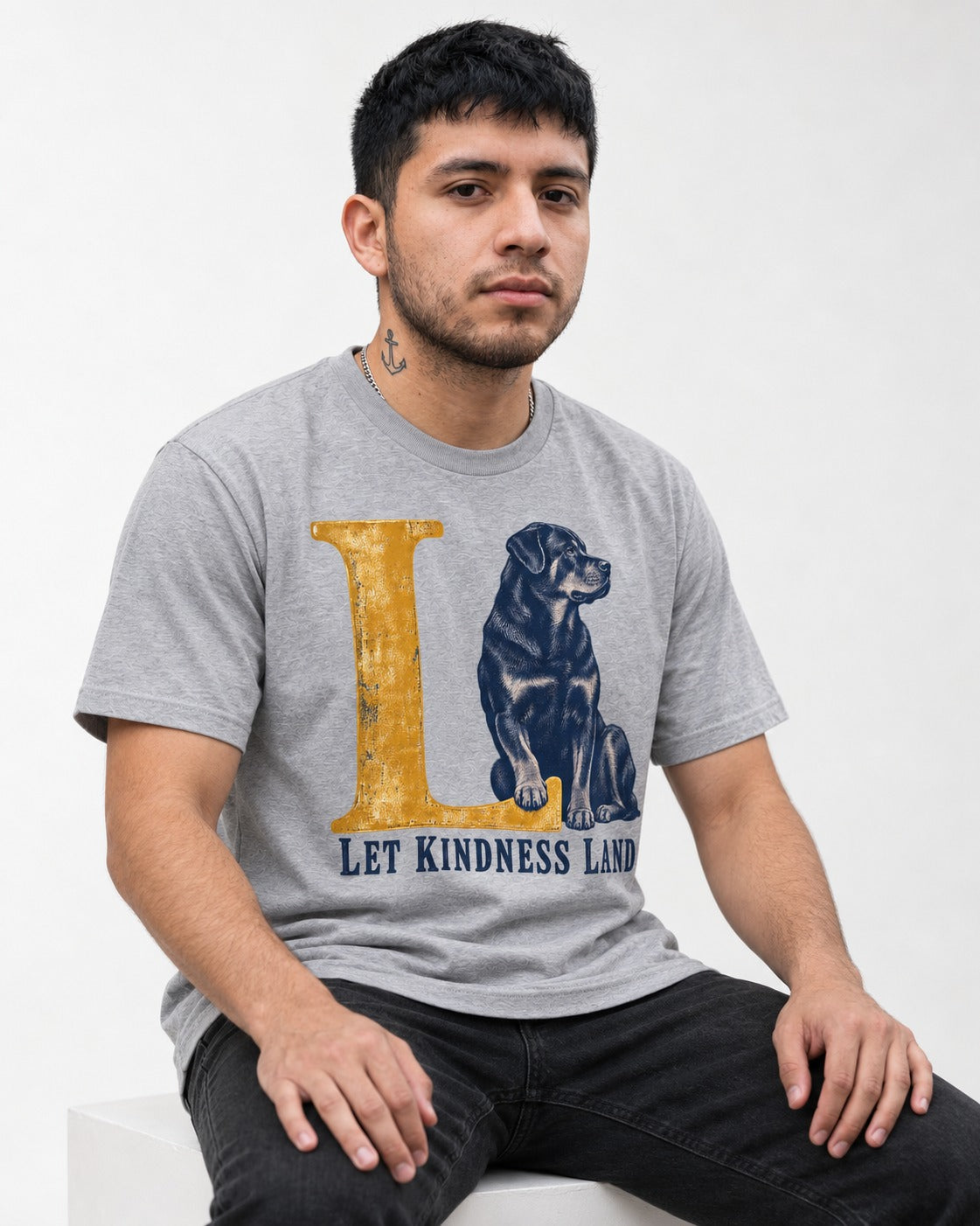 Let Kindness Lead Rottweiler T-Shirt in Sport Grey, worn by a seated model