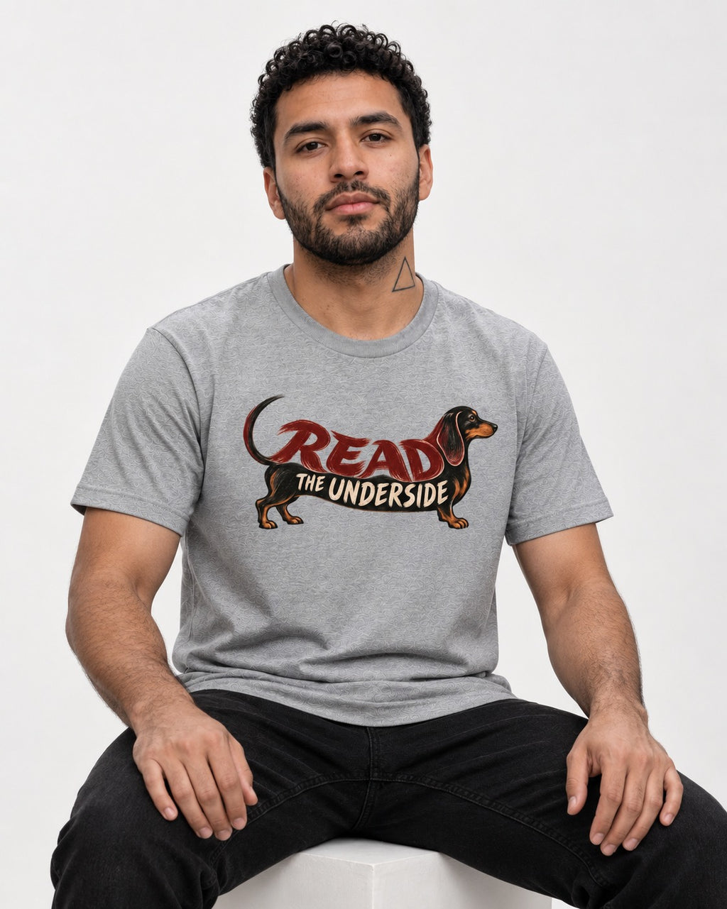 Dachshund Read The Underside Body Lettering Graphic T-Shirt in Sport Grey, worn by a seated model