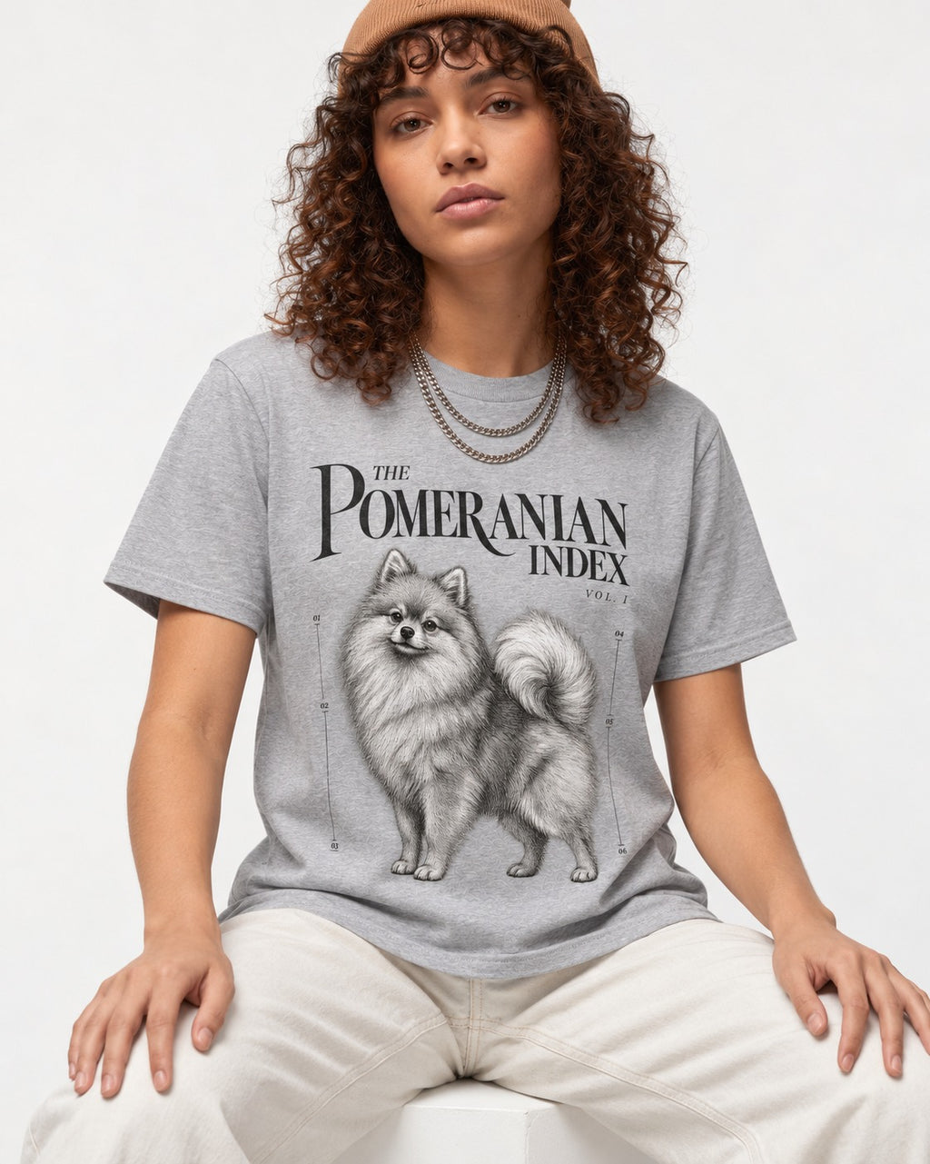 The Pomeranian Index T-Shirt in Sport Grey, worn by a seated model