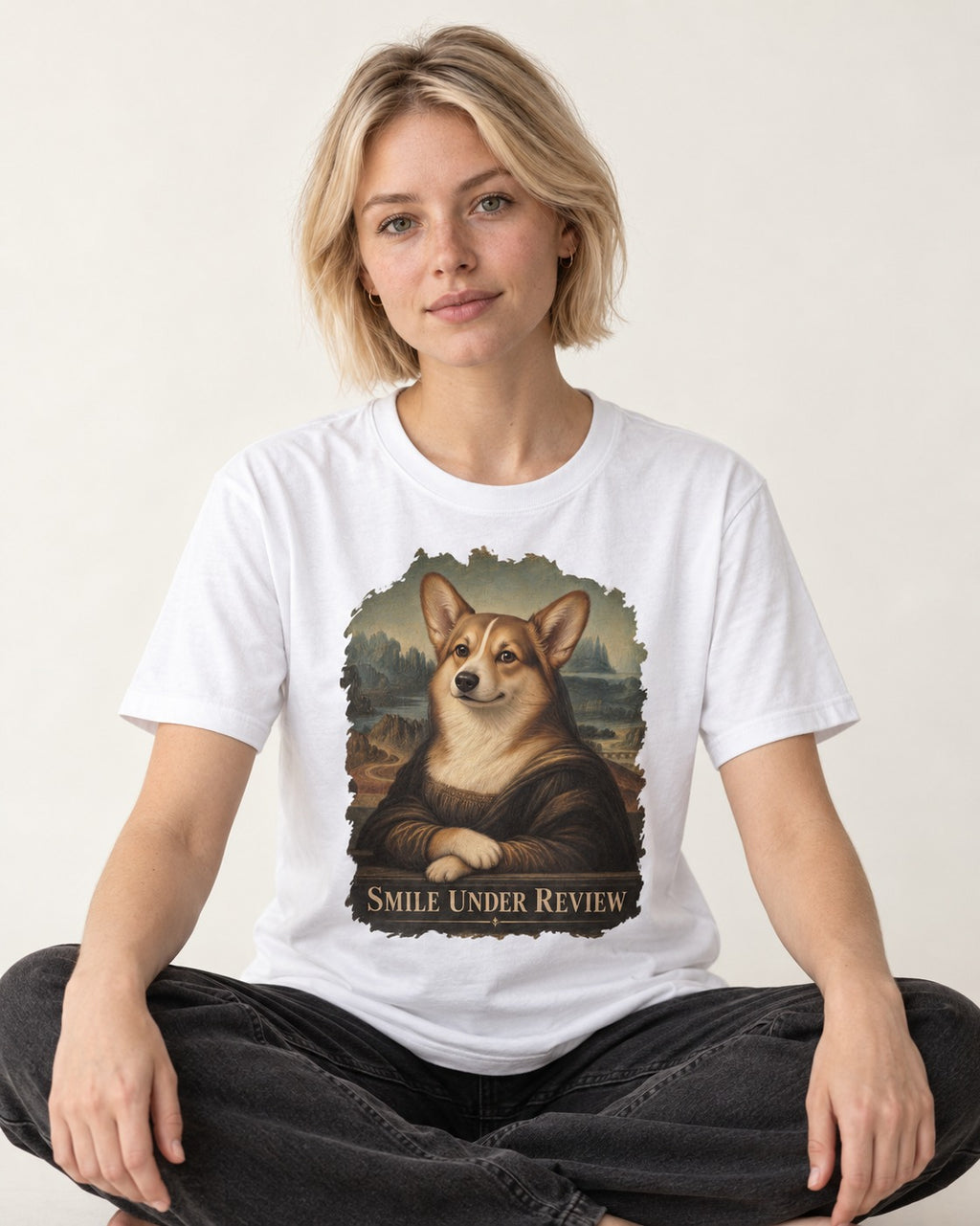 Corgi Smile Under Review Mona Lisa Portrait T-Shirt in White, worn by a seated model