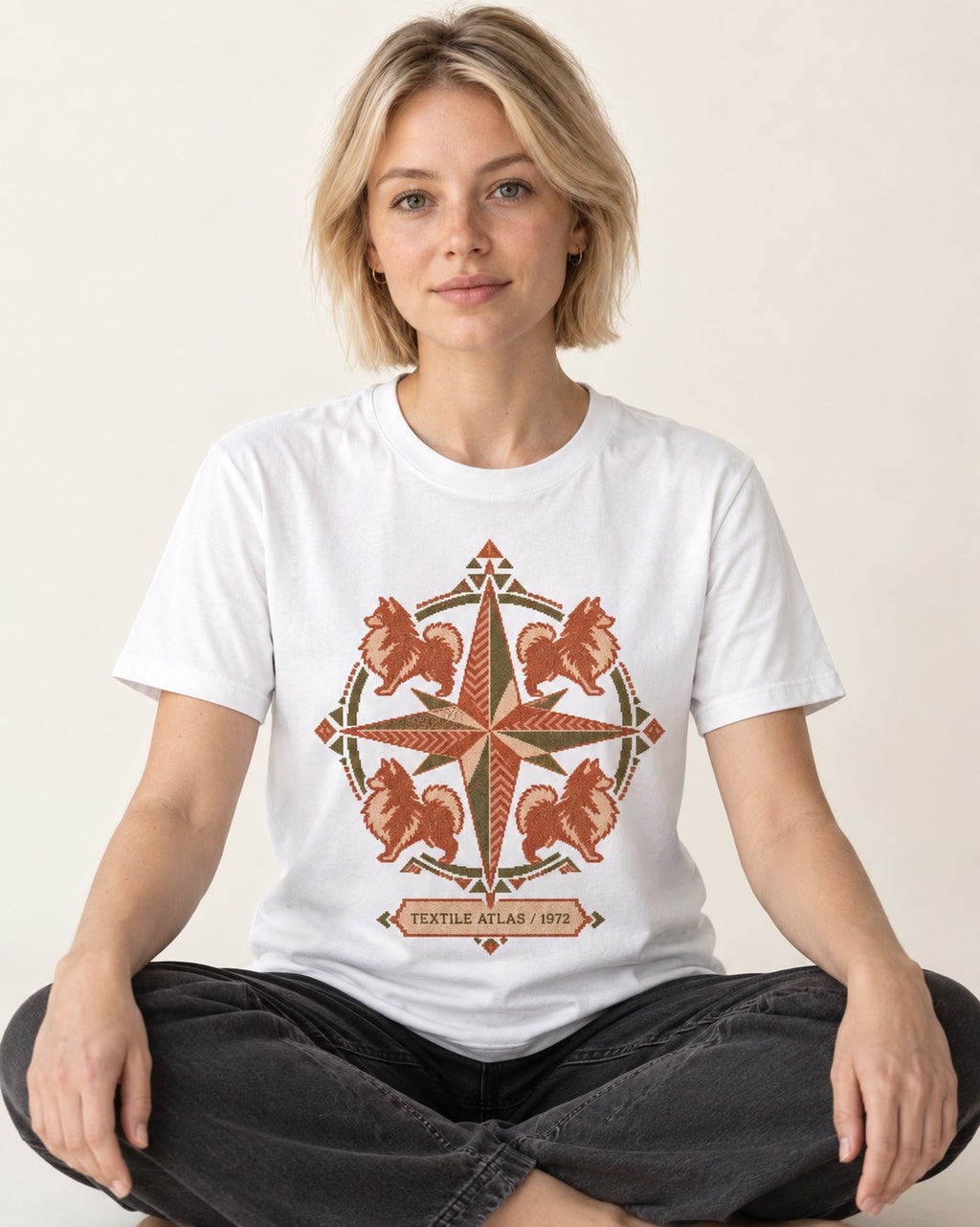 Pomeranian Textile Atlas Compass Rose Graphic T-Shirt in White, worn by a seated model