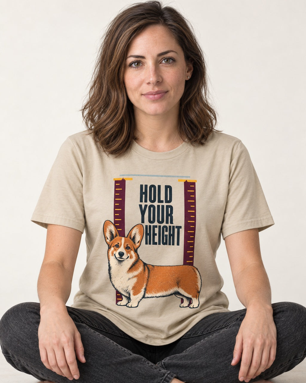 Corgi Hold Your Height T-Shirt in Sand, worn by a seated model