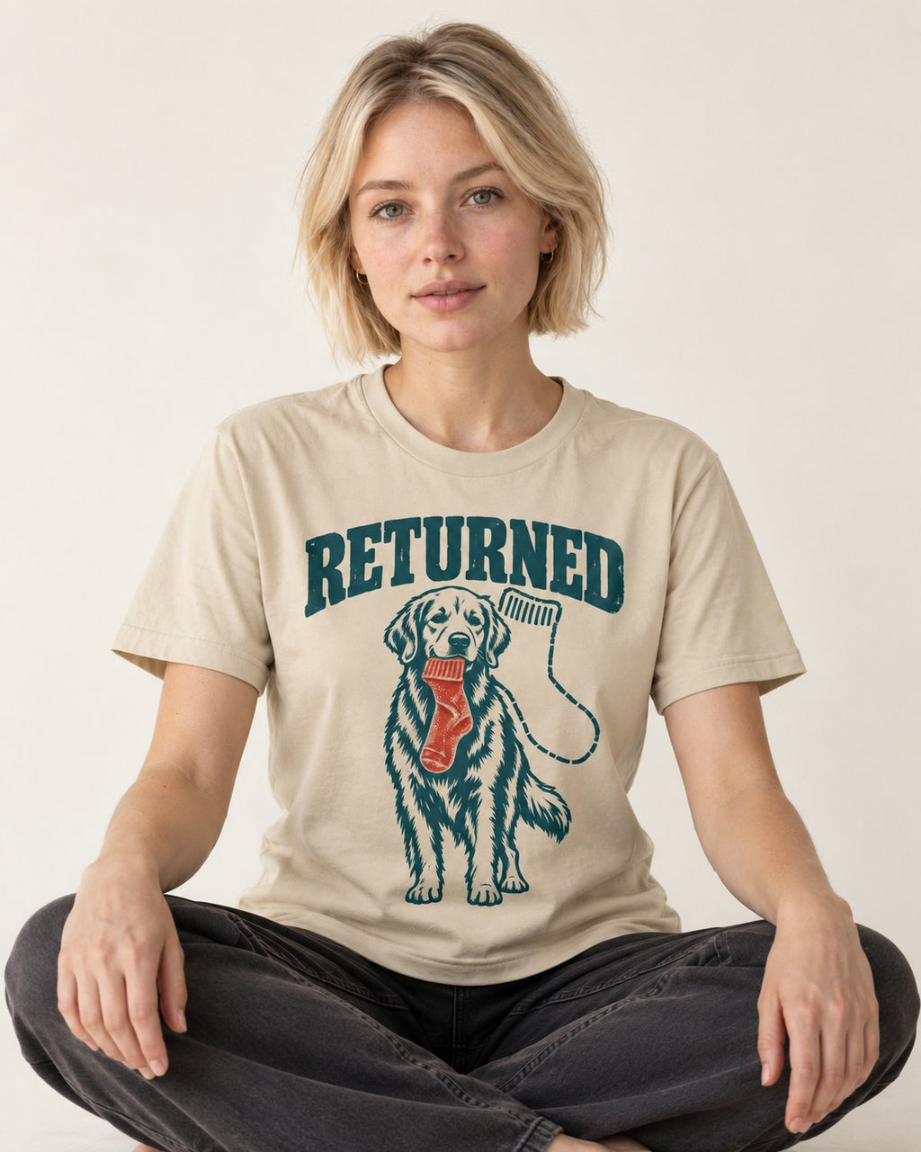 Golden Retriever Returned T-Shirt in Sand, worn by a seated model