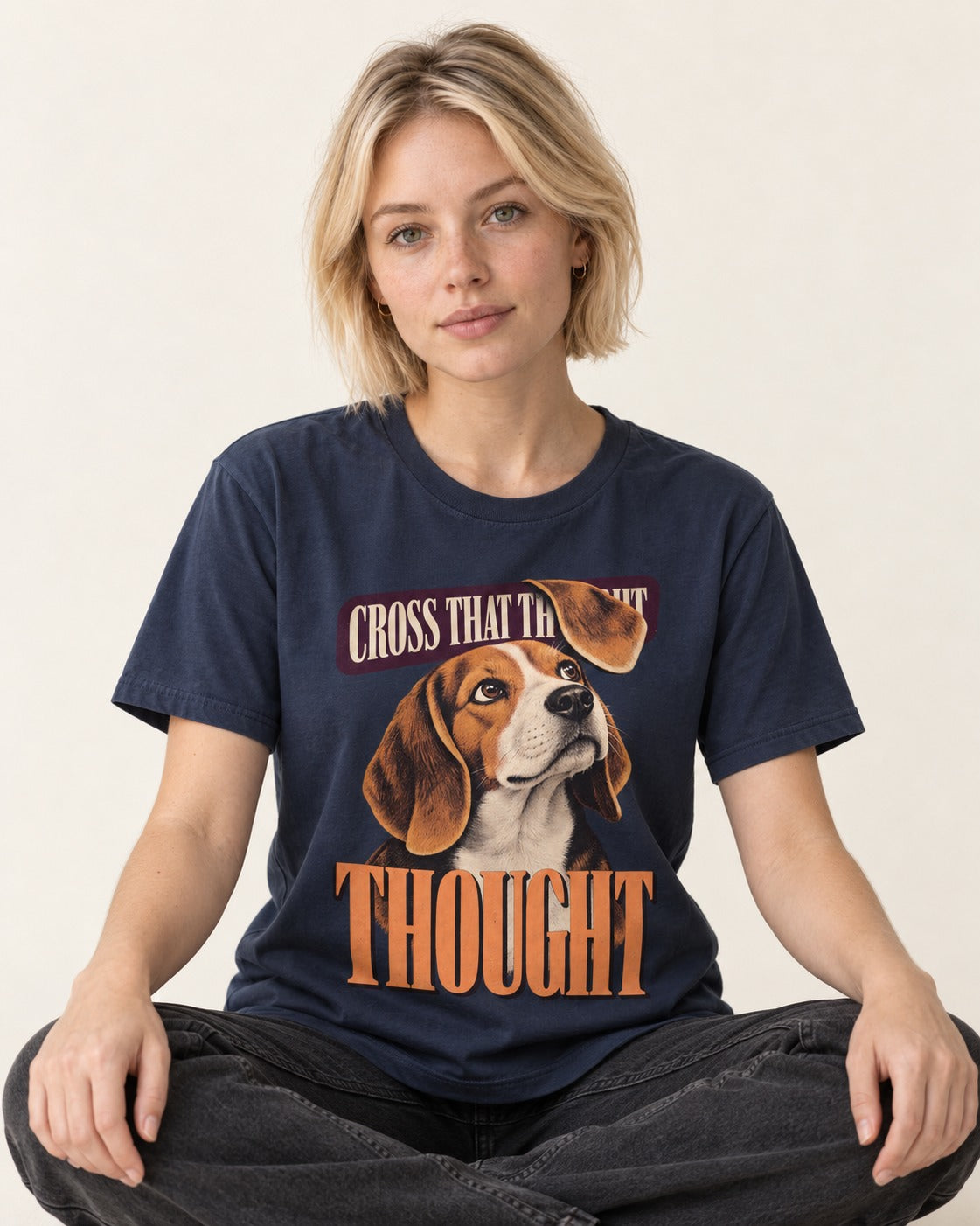 Cross That Beagle Thought T-Shirt in Navy, worn by a seated model